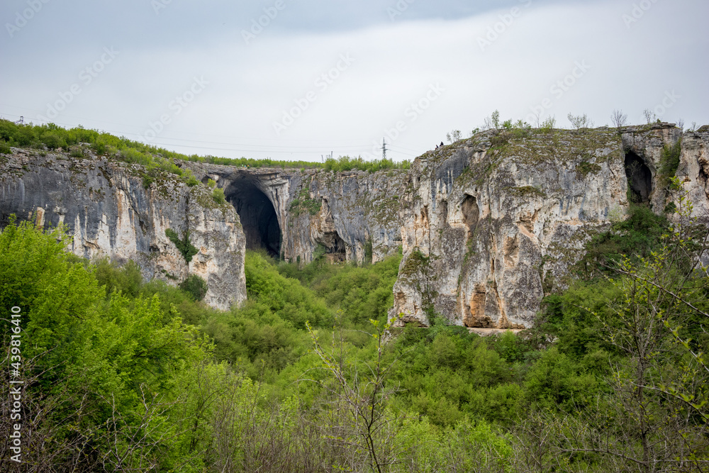The huge entrance of Prohodna cave as seen from far away. Northern Bulgaria, Beauty in Nature