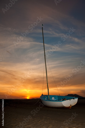 Beached sailboat and stunning sunset