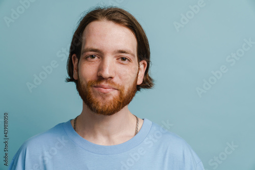 Young ginger man with beard posing and looking at camera