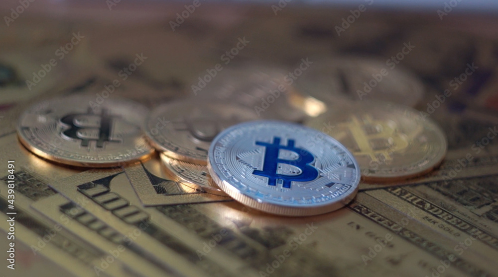 Camera moving around bitcoin coins and golden money dollars and euro on the background.