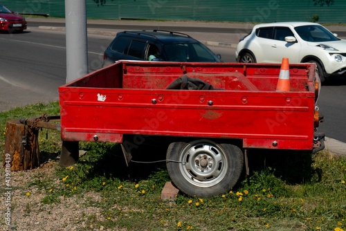 Red car trailer on two wheels with an open top. photo