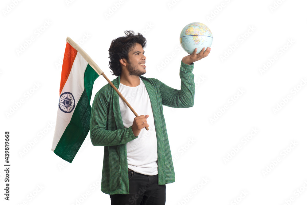 Fototapeta premium Young man with Indian flag or tricolor with world globe on white background, Indian Independence day, Indian Republic day