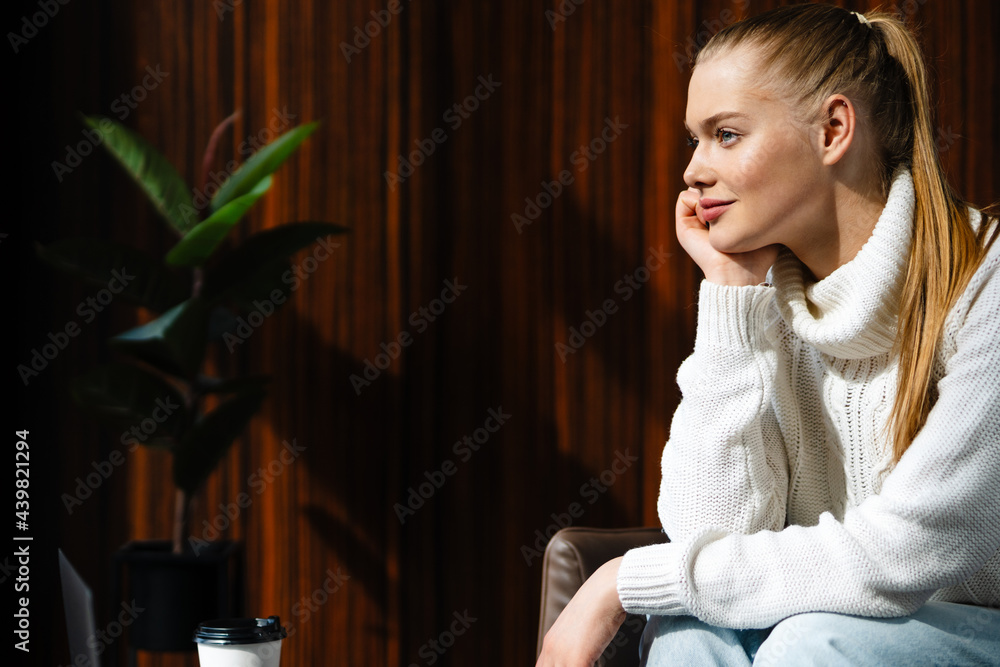 Young pensive white woman with blonde hair