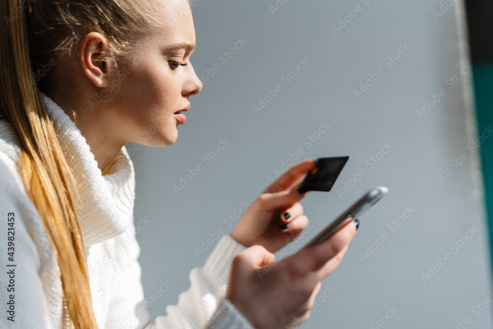 Close up of a young blonde woman shopping online Close up of a young blonde woman shopping online