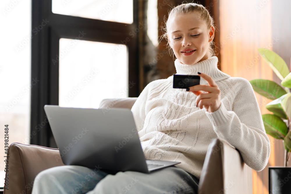 Happy smiling blonde white woman shopping online