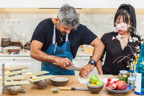 Latin cooks preparing sushi for dinner