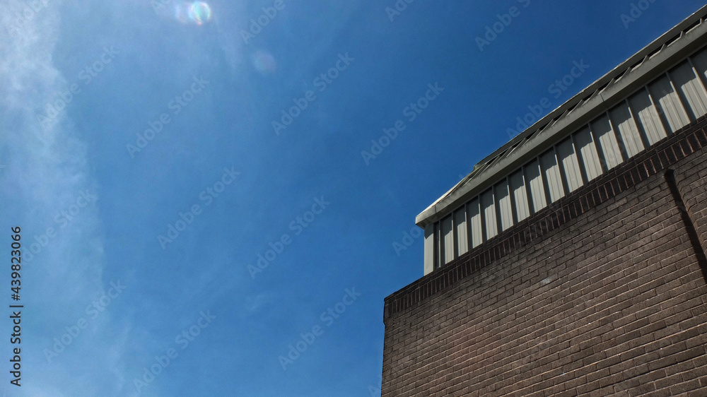 Fototapeta premium City-scapes looking up on a bright sunny summer day. Bright sky with space for text.