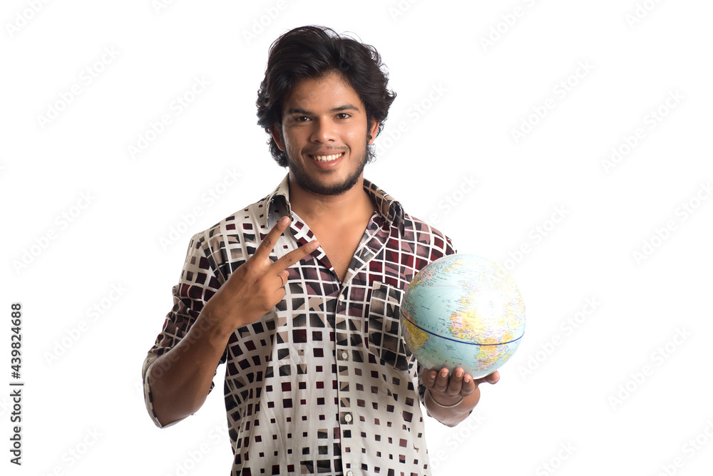 young man with a world globe on a white background. young man with a world globe on a white background.