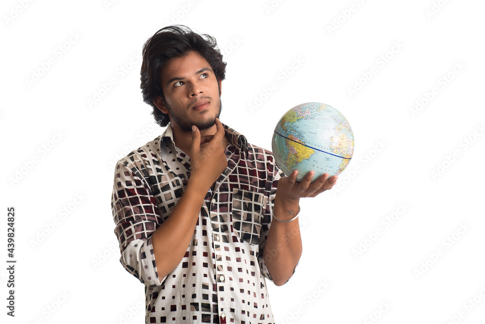 young man with a world globe on a white background. young man with a world globe on a white background.