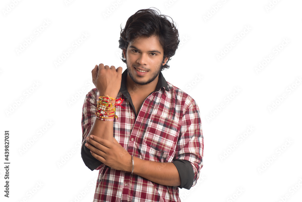 Young men showing rakhi on his hand on an occasion of Raksha Bandhan festival. Young men showing rakhi on his hand on an occasion of Raksha Bandhan festival.