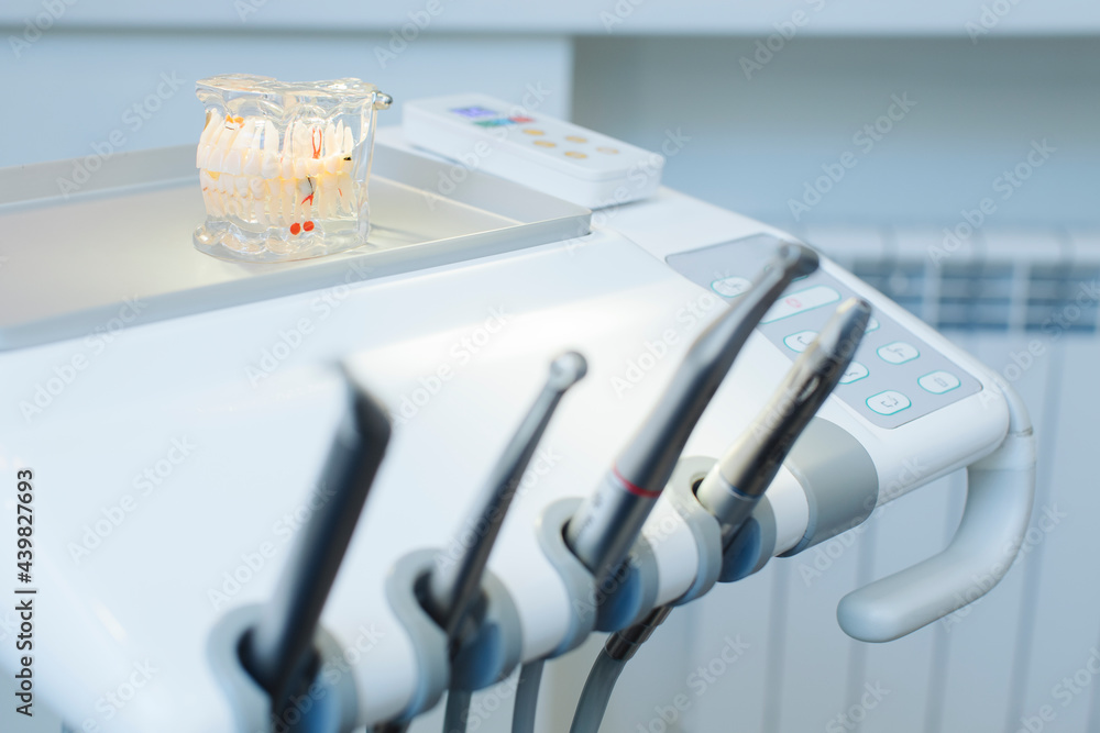 Exhibit of a person's jaw with various defects such as caries and paradanthosis, lies on the dental apparatus in the doctor's office Exhibit of a person's jaw with various defects such as caries and paradanthosis, lies on the dental apparatus in the doctor's office
