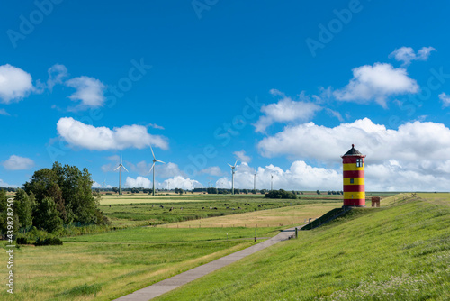 Dike landscape with Pilsum lighthouse near Pilsum