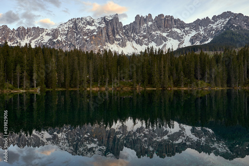 beautiful landscape of the lago di carezza with the reflection of the mountain and pine trees in the lake in the Italian Dolomites © Vicente
