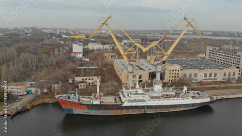Konstfotografi Ariel view of old cargo ship is moored at the dock on the river