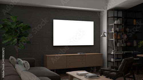 Glowing TV screen mock up at night in the living room with concrete wall.