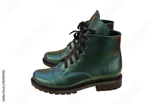 Green leather shoes isolated on white background. Winter and spring off-season boots. Stylish boot. Close-up. Laces, tractor sole. Casual style. Pearlescent fashionable color
