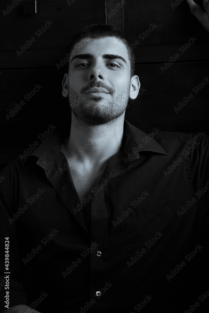 Portrait of handsome man with beard looking at camera with dark eyes Portrait of handsome man with beard looking at camera with dark eyes