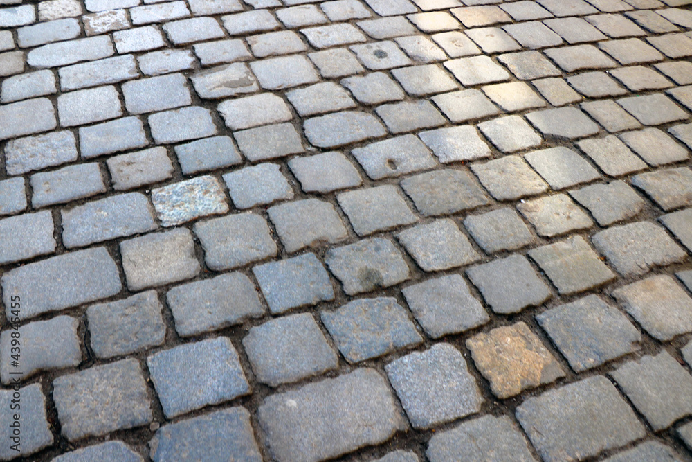 Gray texture of paving stones in the old part of the city.