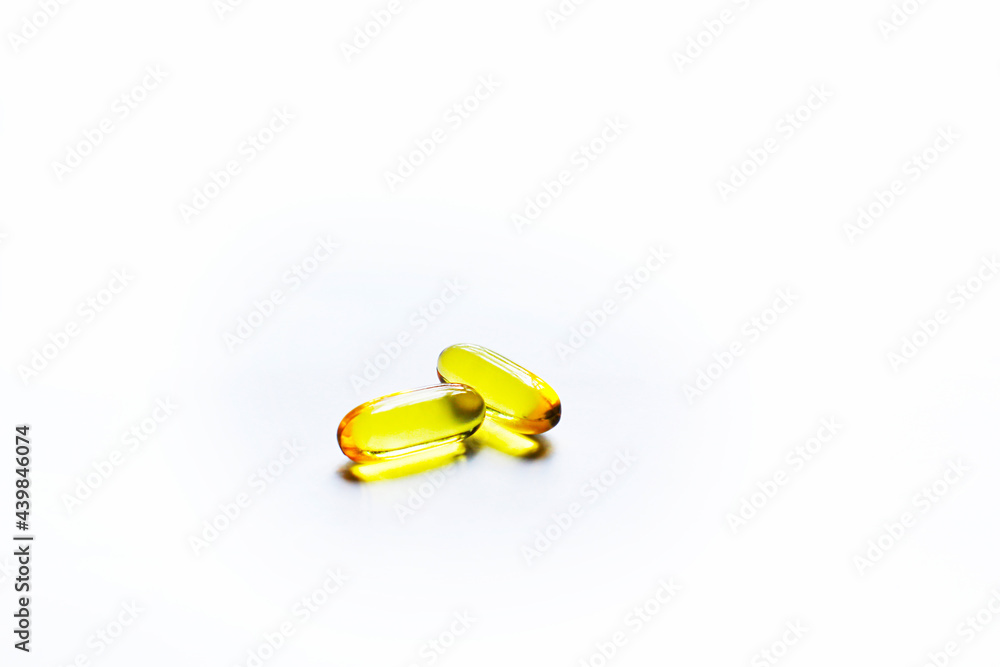 Fish oil capsules on white background and texture., Fish oil capsules and container., selective focus. Fish oil capsules on white background and texture., Fish oil capsules and container., selective focus.