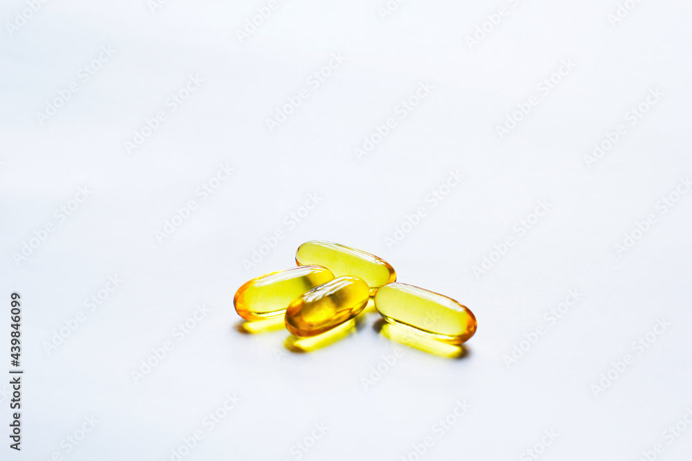 Fish oil capsules on white background and texture., Fish oil capsules and container., selective focus. Fish oil capsules on white background and texture., Fish oil capsules and container., selective focus.