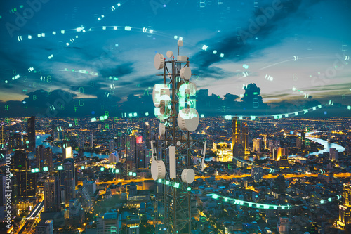 Telecommunication tower with 5G cellular network antenna on night city background, Digital big data concept