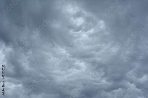 Blue and dark grey heavy clouds in the sky before a thunderstorm. Dramatic backdrop or wallpaper. Natural dangerous menacing background. Ahead of a storm or cataclysm. High quality photo