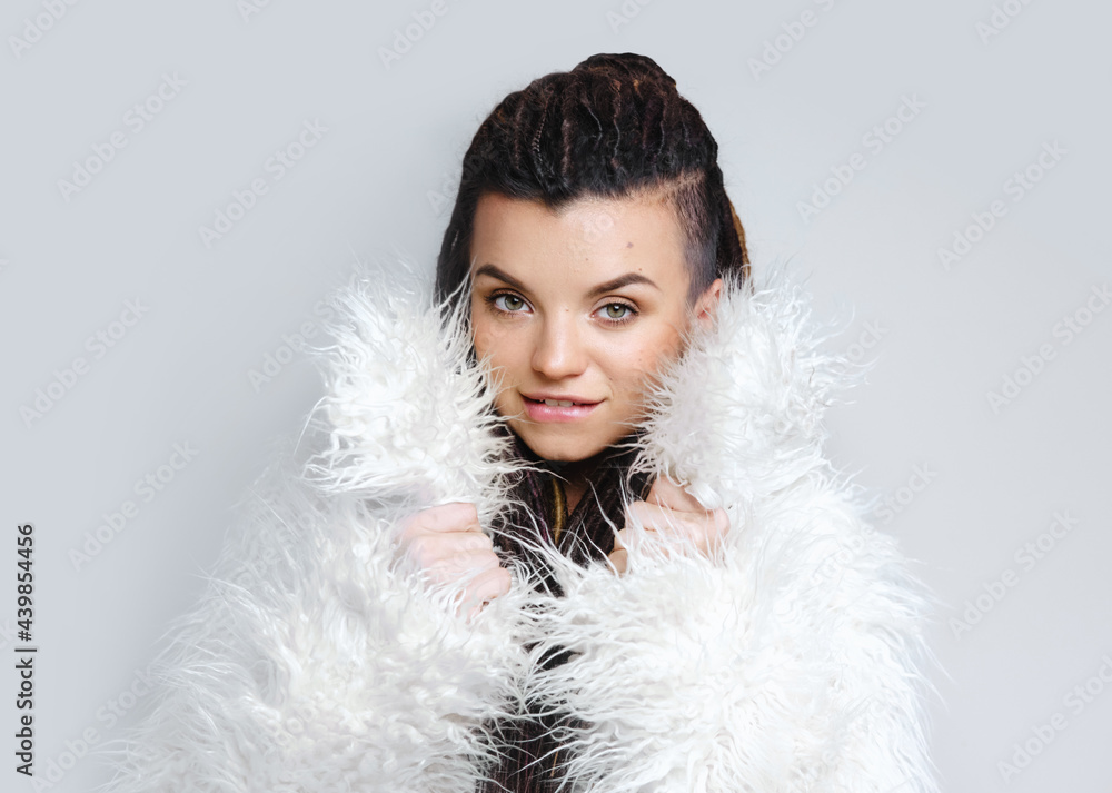 Portrait of a beautiful girl with dreadlocks. Fashionable fur coat. Beauty. Portrait of a beautiful girl with dreadlocks. Fashionable fur coat. Beauty.