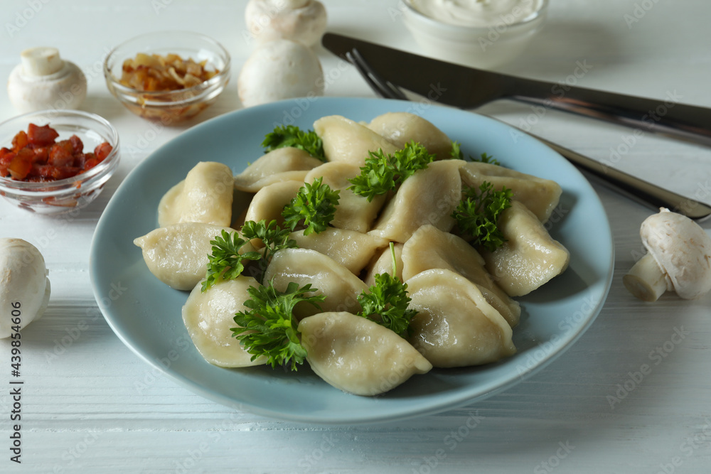 Concept of tasty food with vareniki or pierogi on wooden table Concept of tasty food with vareniki or pierogi on wooden table