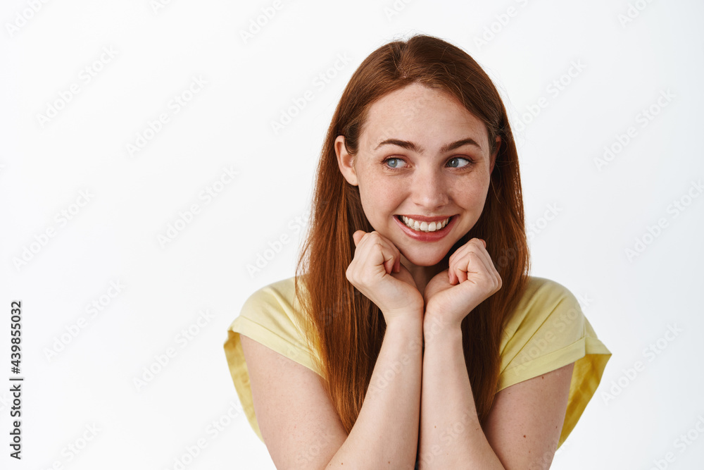 Cute and silly ginger girl, smiling and looking romantic aside at logo, lean on hands and daydreaming, thinking of something nostalgic, white background Cute and silly ginger girl, smiling and looking romantic aside at logo, lean on hands and daydreaming, thinking of something nostalgic, white background