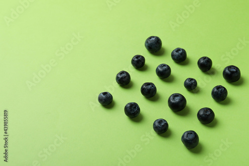 Fresh berry concept with blueberry on green background