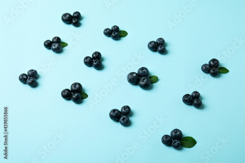Fresh blueberry with leaves on blue background