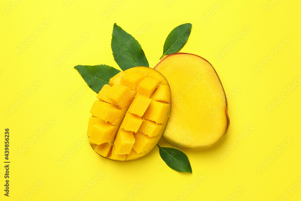 Ripe mango fruit on yellow background, close up