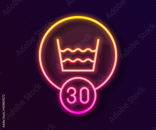 Glowing neon line Washing under 30 degrees celsius icon isolated on black background. Temperature wash. Vector