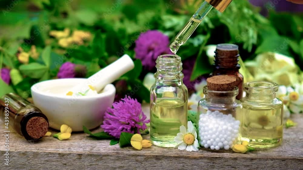 Homeopathy is a tincture of medicinal herbs in a small bottle. Selective focus. Homeopathy is a tincture of medicinal herbs in a small bottle. Selective focus.