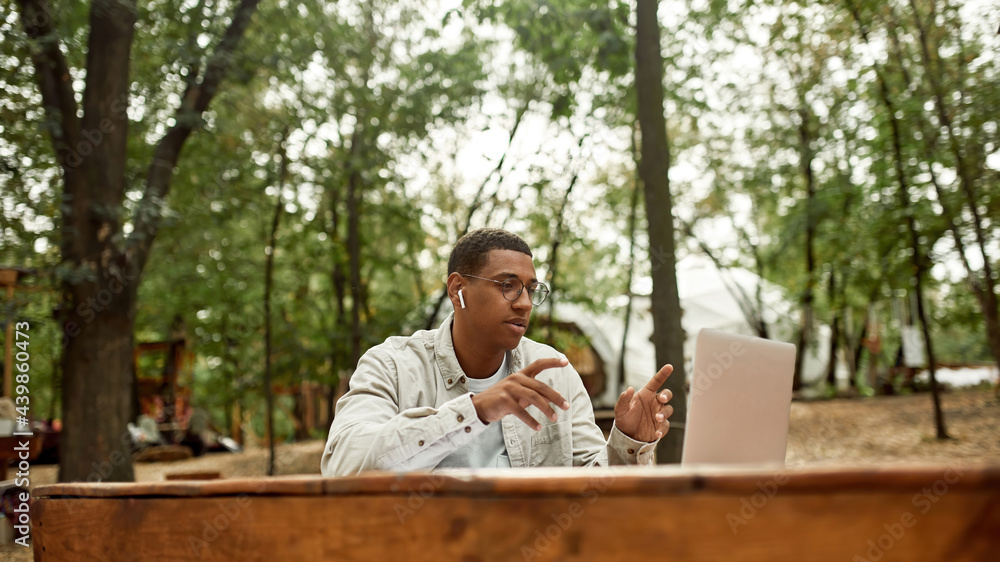 Fototapeta premium Young african american man talking via webcam