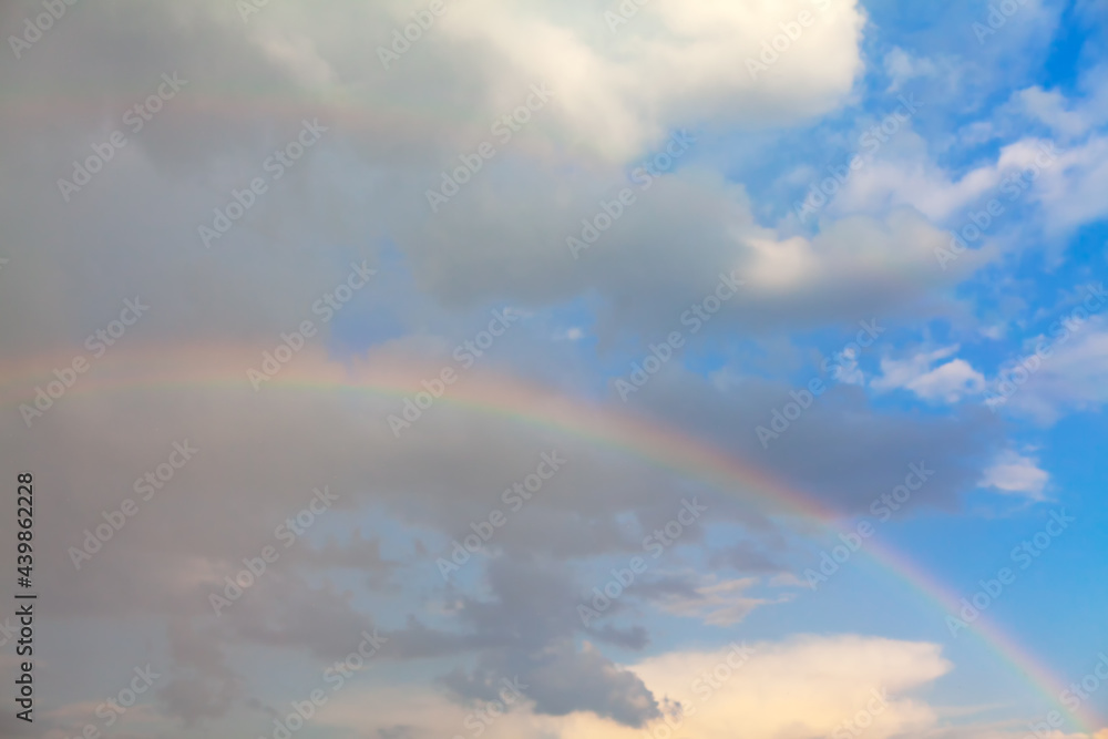 Real rainbow in the summer day . Natural spectrum on the sky 