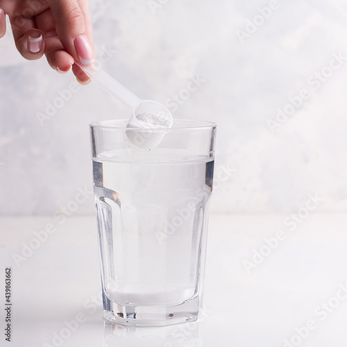 Female hand preparing a drink for athletes. White background