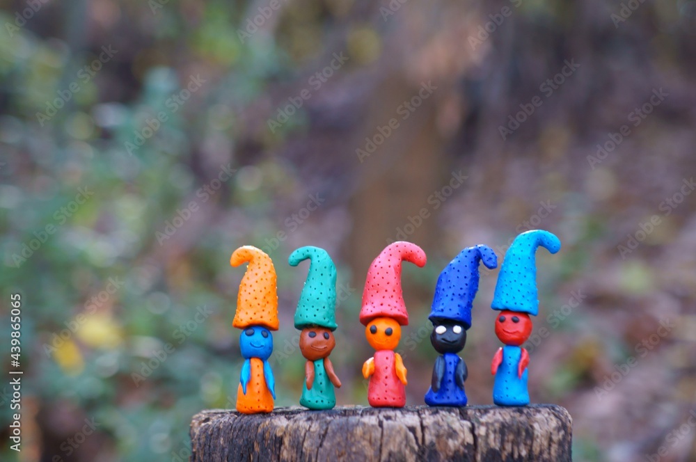 Figures of multi-colored gnomes on a colored background.