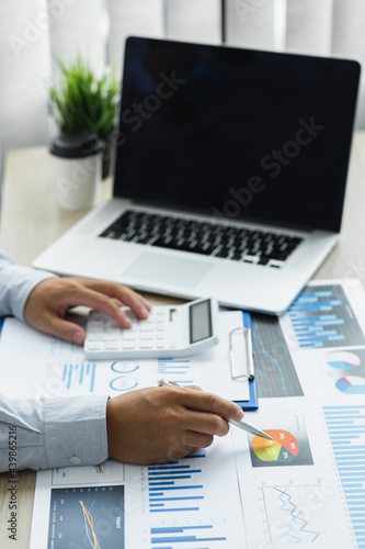 Financial Businessman analyze the graph of the company's performance to create profits and growth, Market research reports and income statistics, Financial and Accounting concept.