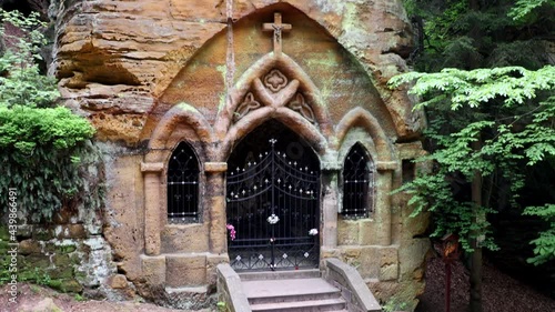 The chapel carved into the rock wall, inside the altar with a statue of the Virgin Mary, from the 18th and 19th centuries, Svojkov, Czechia. photo