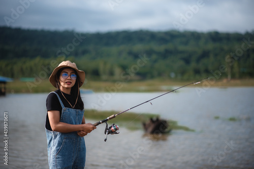 girl camping and she stands fishing