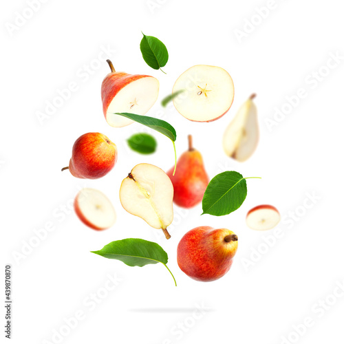 Fototapeta Naklejka Na Ścianę i Meble -  Flying red ripe juicy pear and green leaves isolated on white background. Sweet whole pears and sliced. Summer healthy organic fruits, harvesting. Creative composition with pears. Food concept