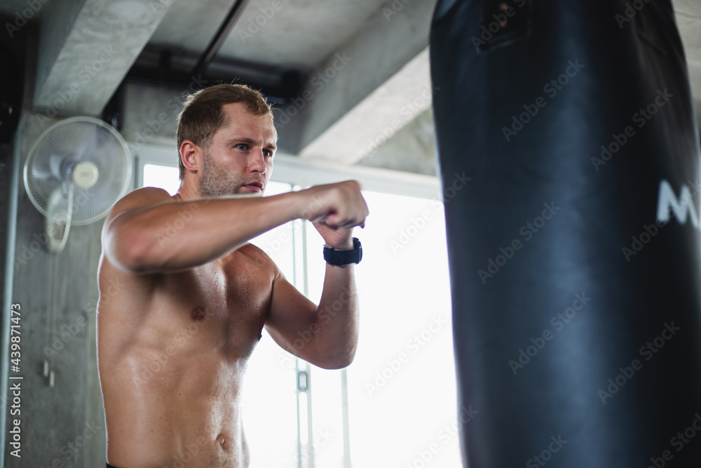Caucasian muscular man boxing training exercise in gym fitness. Boxer workout punching bag fist. fighting sport. Healthy wellness lifestyle concept