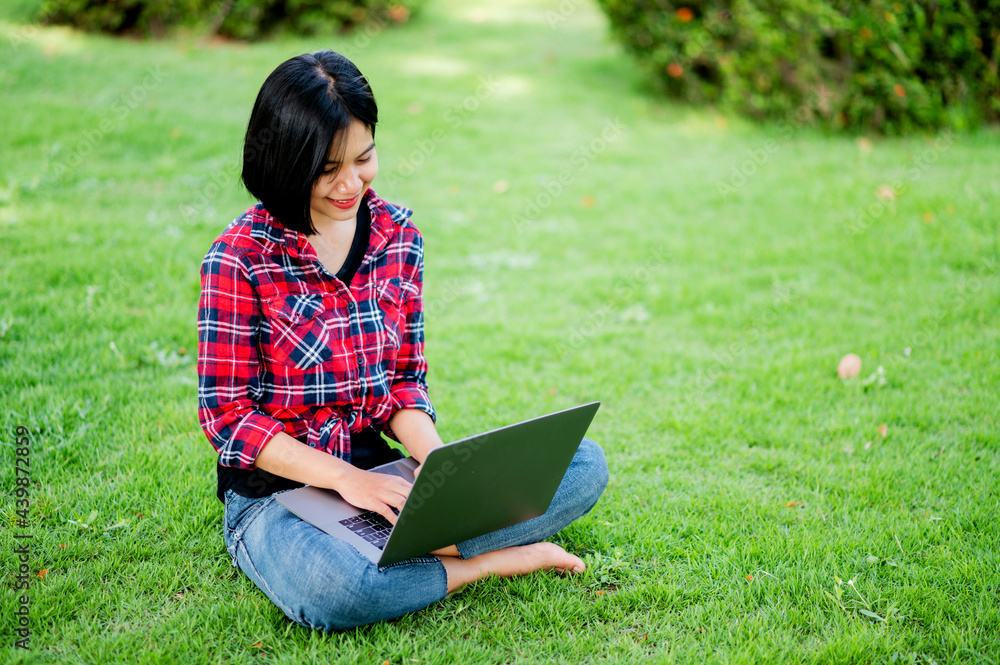 Asian women smile happily and laptop. Work online online communication Messaging Online learning Online communication concept Asian women smile happily and laptop. Work online online communication Messaging Online learning Online communication concept