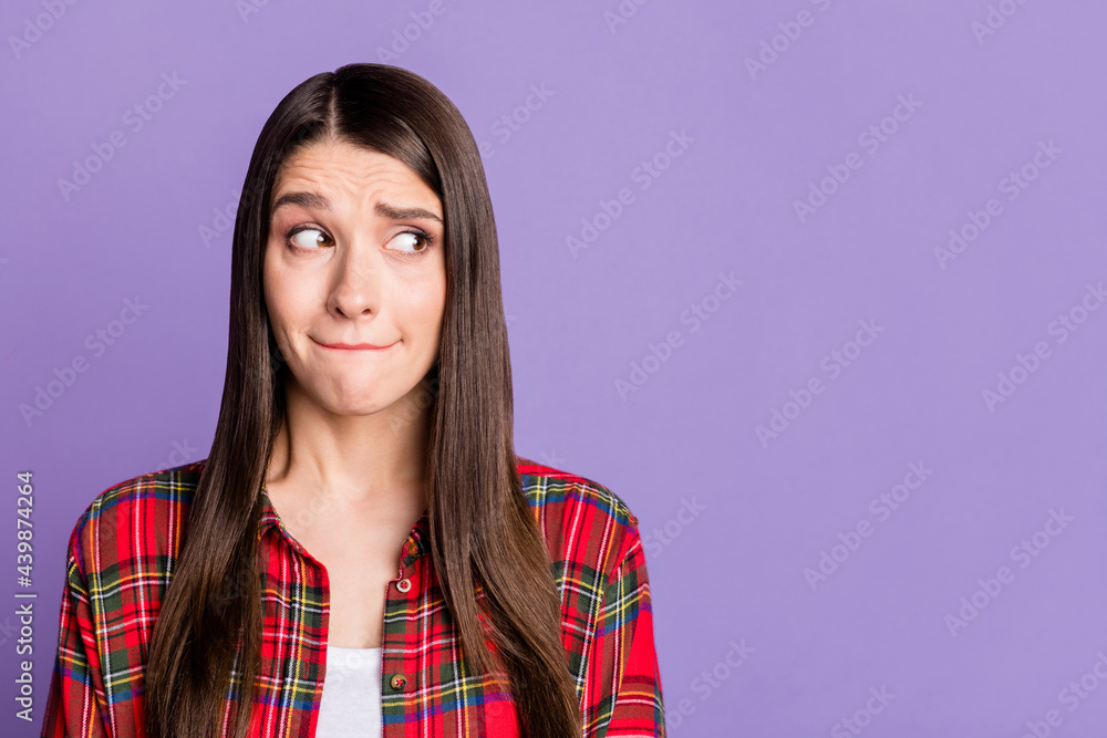 Photo of scared brunette hairdo millennial lady look empty space wear red shirt isolated on purple color background Photo of scared brunette hairdo millennial lady look empty space wear red shirt isolated on purple color background
