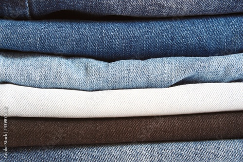 Stack of jeans, denim jeans texture background.
