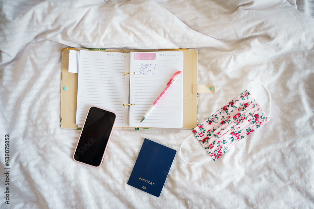 passport, mask, notebook and phone on a white background passport, mask, notebook and phone on a white background