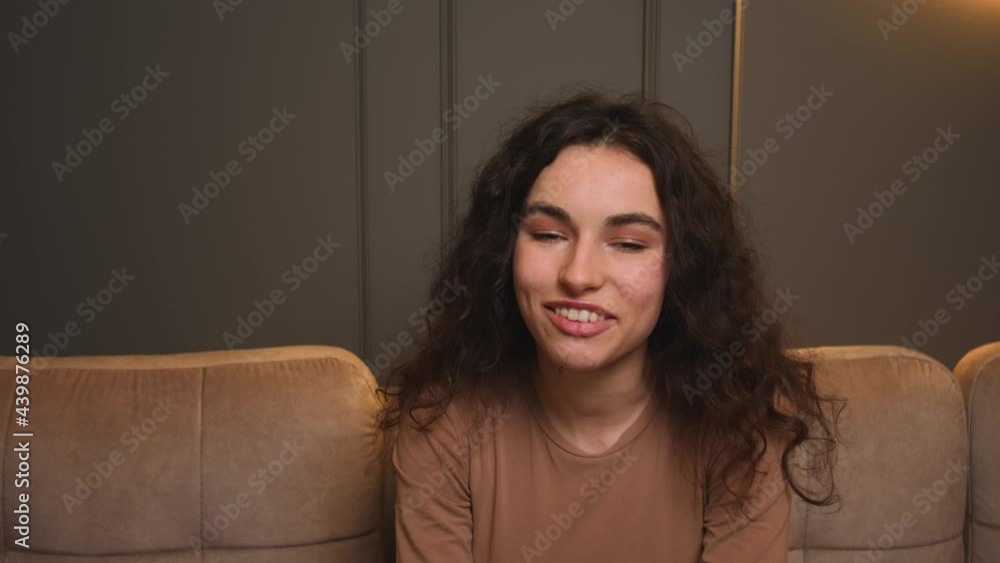 Portrait of Smiling woman speaking looking at camera talking make video conference on couch at home office. Doing video chat at home concept, webcam view. Portrait of Smiling woman speaking looking at camera talking make video conference on couch at home office. Doing video chat at home concept, webcam view.