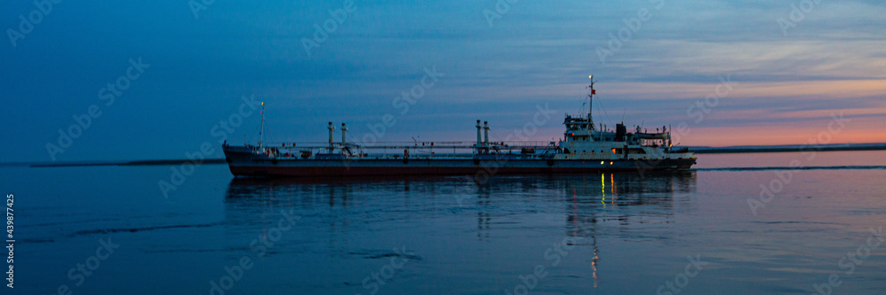cargo ship at sunset in the bay