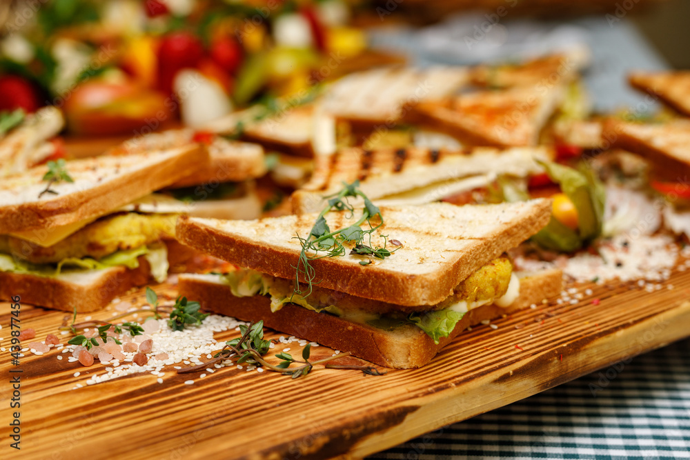 Sandwiches on a wooden tray. Sandwiches on a wooden tray.